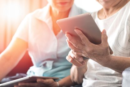 Two people look at a tablet together.