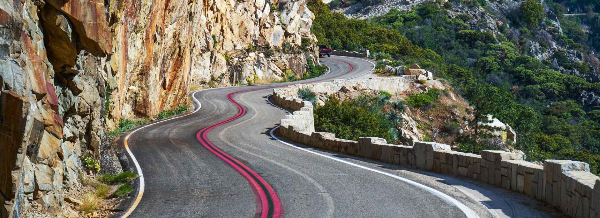 A winding road in the mountains can be seen.