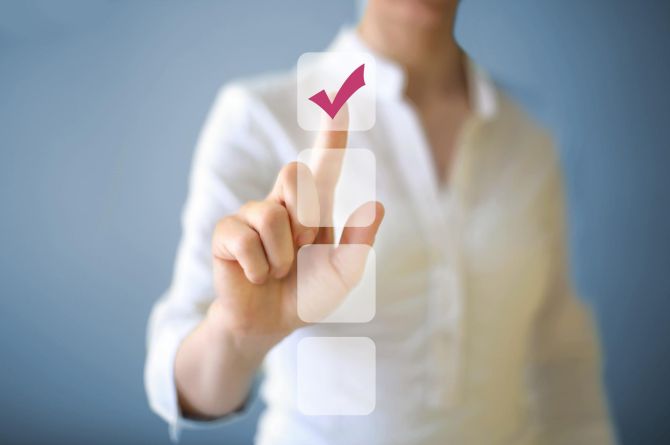 Eine männliche Hand wählt ein Kästchen auf einer imaginären Scheibe aus.