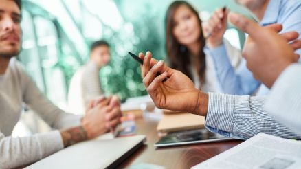 A team of employees discusses a project.