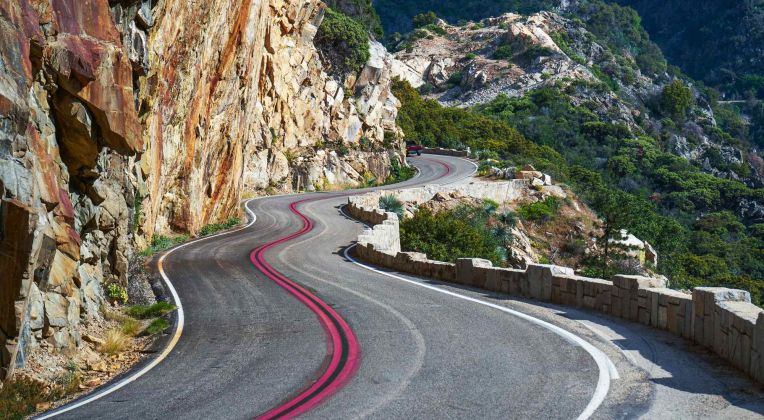 A winding road in the mountains can be seen.