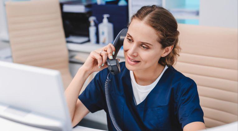 Eine junge Arzthelferin telefoniert