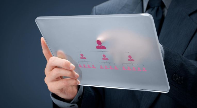We see a transparent tablet on which an organizational chart can be seen.